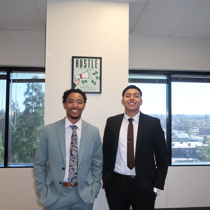 Two Capital Vision Enterprise team members at the office